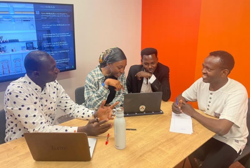 Members of the African Students Organization working together around a laptop.