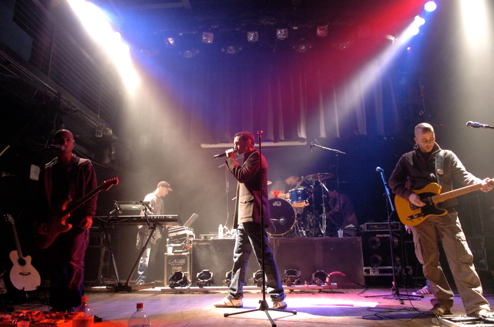 Ivri Lider and his band performing under dramatic stage lights at the Limelight in New York.