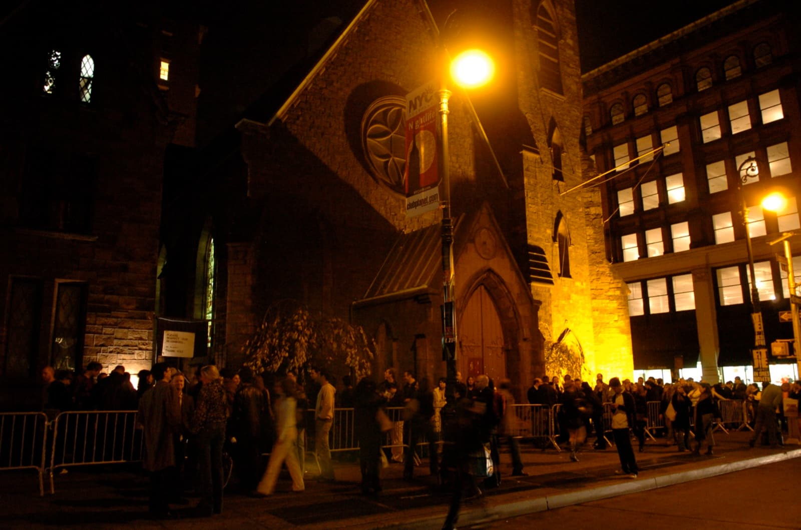 A crowd waiting outside the Limelight, the former Gothic church that housed the New York club, at night.