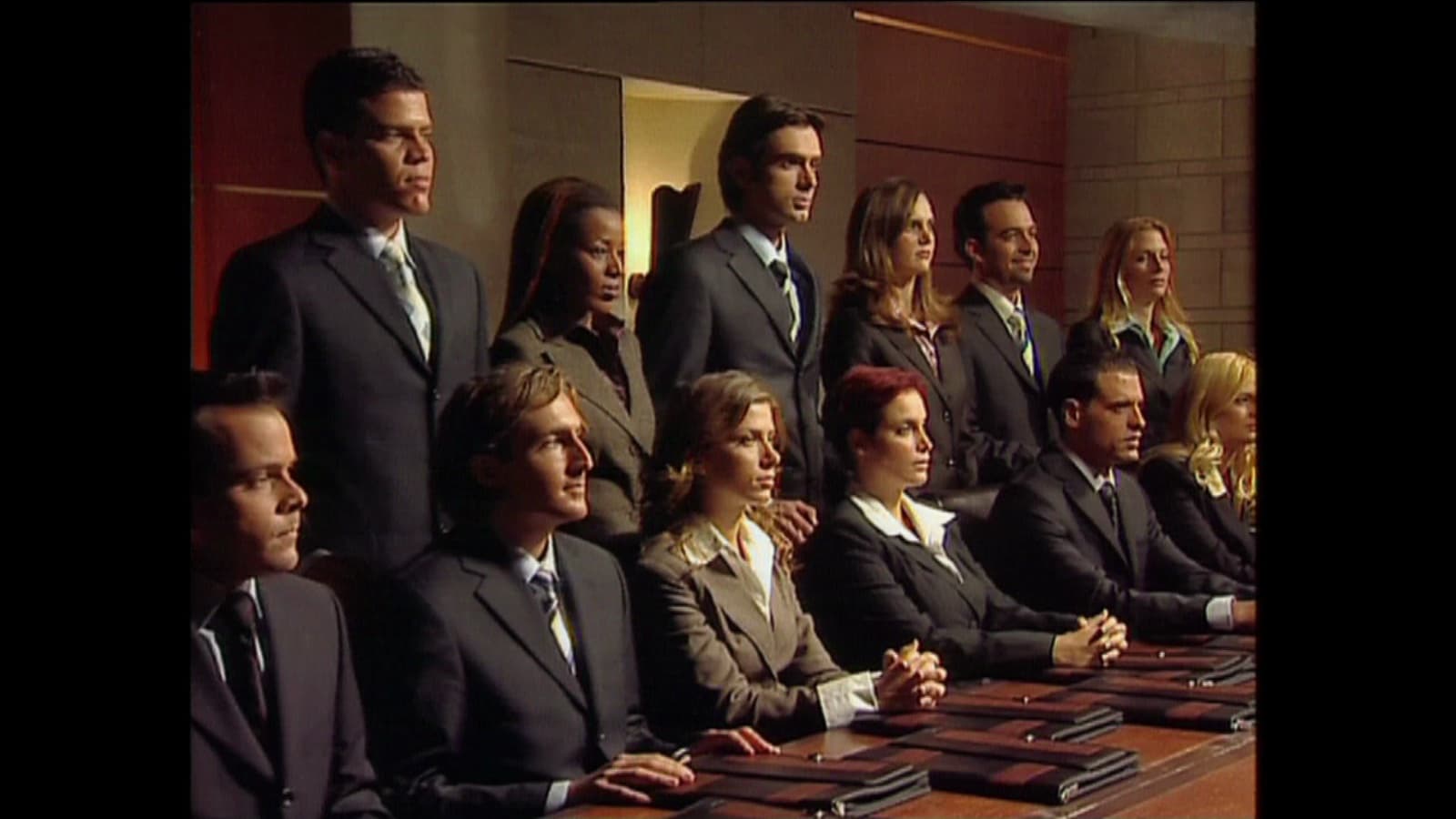 The fourteen contestants of The Ambassador in formal dress, arranged in two rows.
