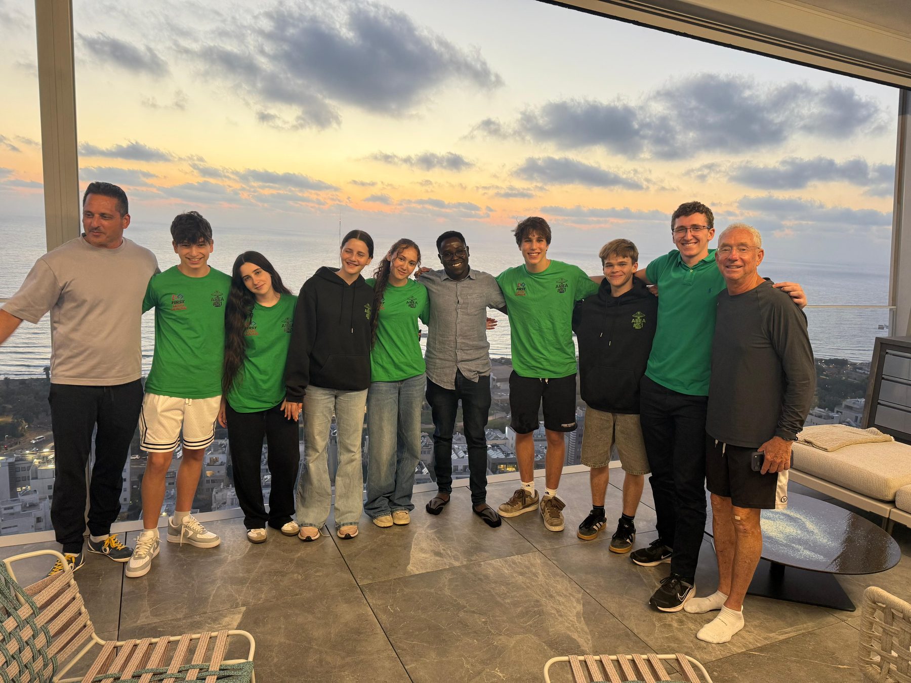 The team gathered with supporters at Joey Low’s home in Israel, overlooking the coastline at sunset.